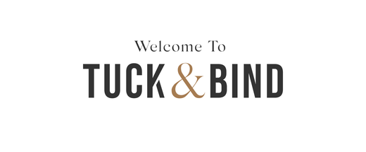 Welcome to tuck and bind logo in black and gold serif font on white background for branding in article Welcome to Tuck & Bind
