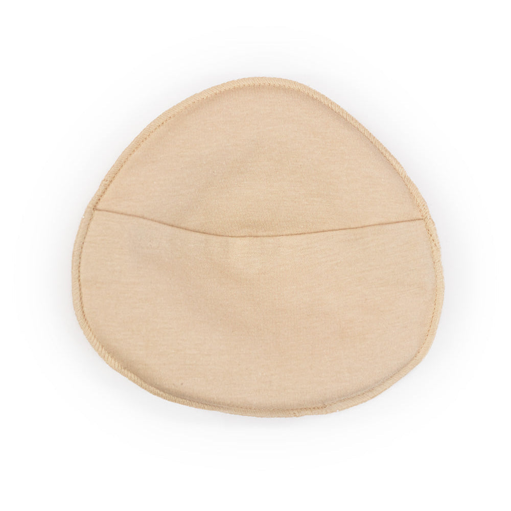 Beige breast form cover with soft padding smooth fabric finish and subtle seam detail for natural shape enhancement
