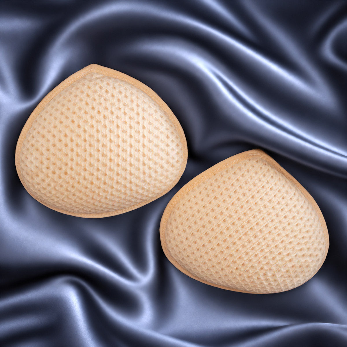 Beige silicone sleep breast forms pair with textured dotted surface designed for comfortable wear