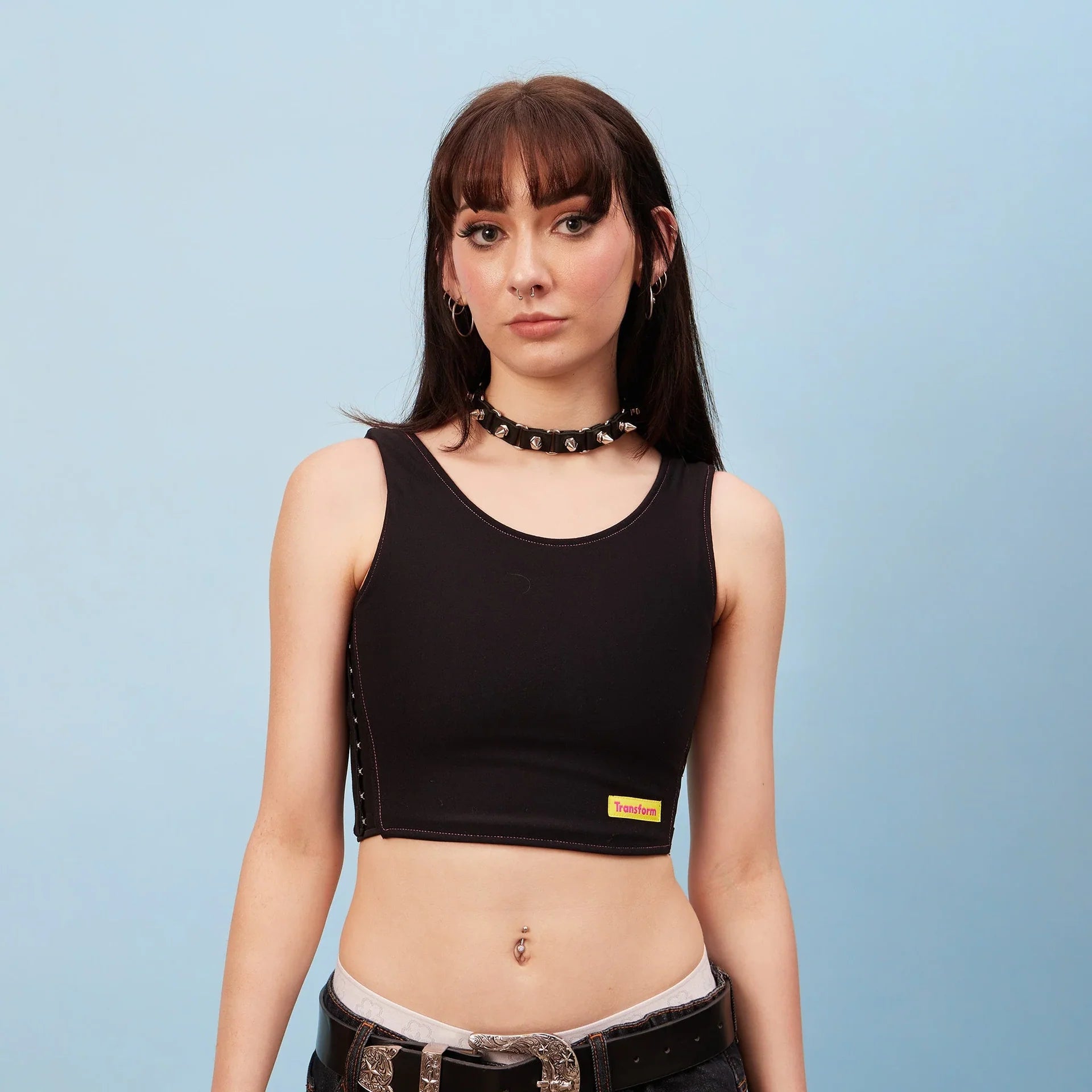 Black sleeveless crop top chest binder with lace-up sides and Transform tag