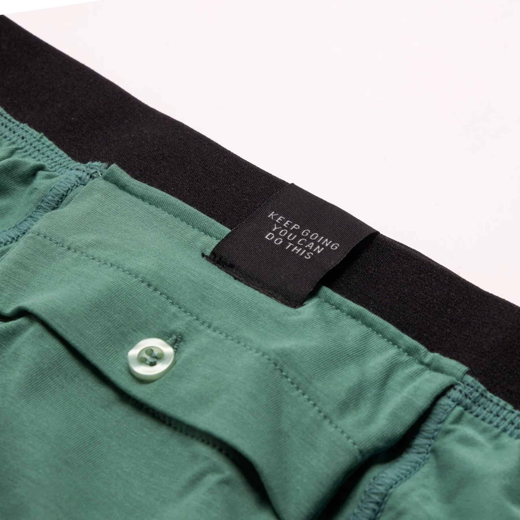 Green cotton All-In-One Packing Boxers with black waistband and white button
