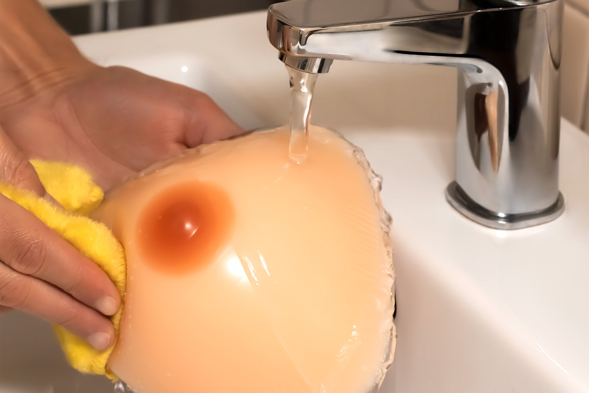 Cleaning a breast form with water and a cloth