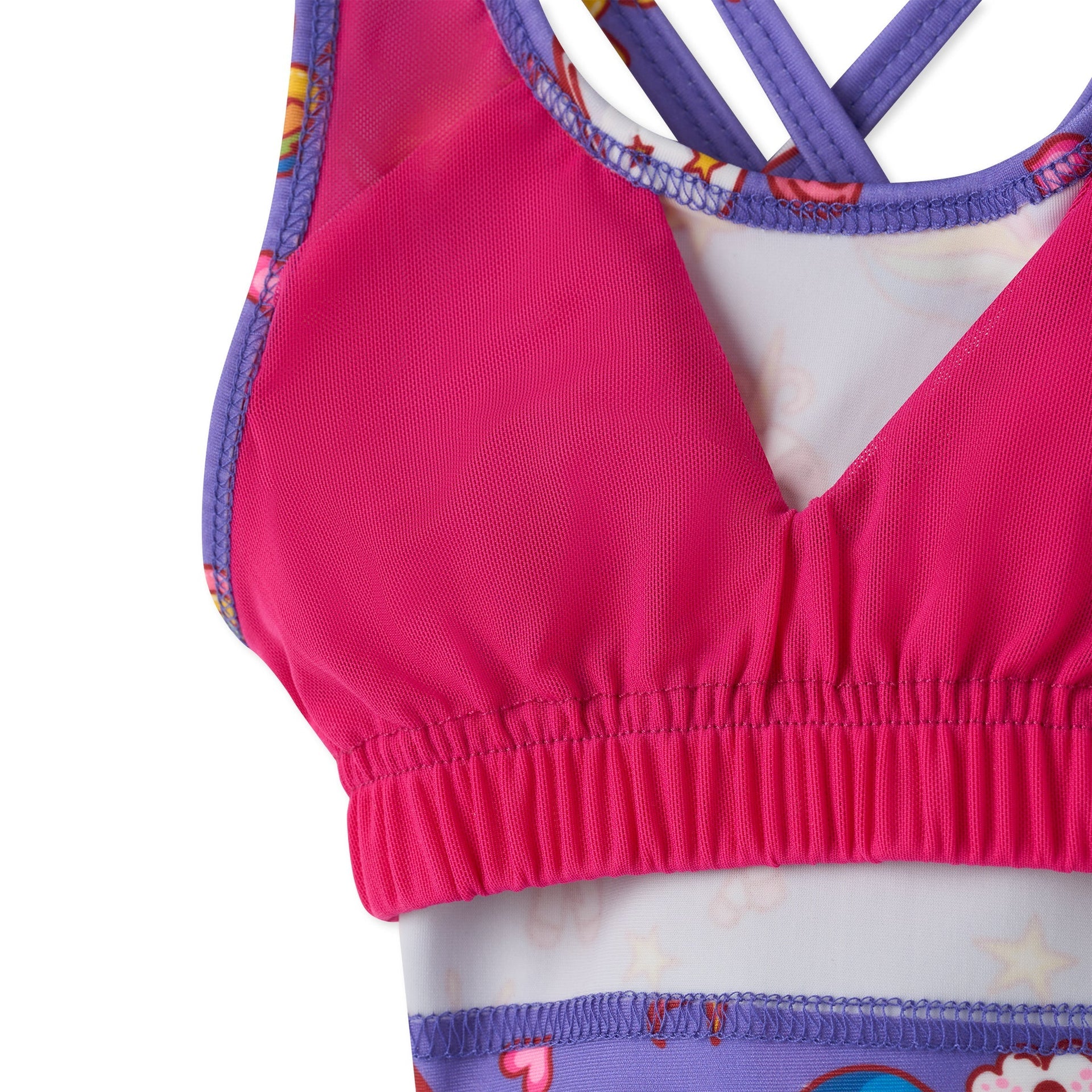 Sunny Queeny tankini with bright pink stretchy fabric, purple crisscross straps, and playful cartoon print