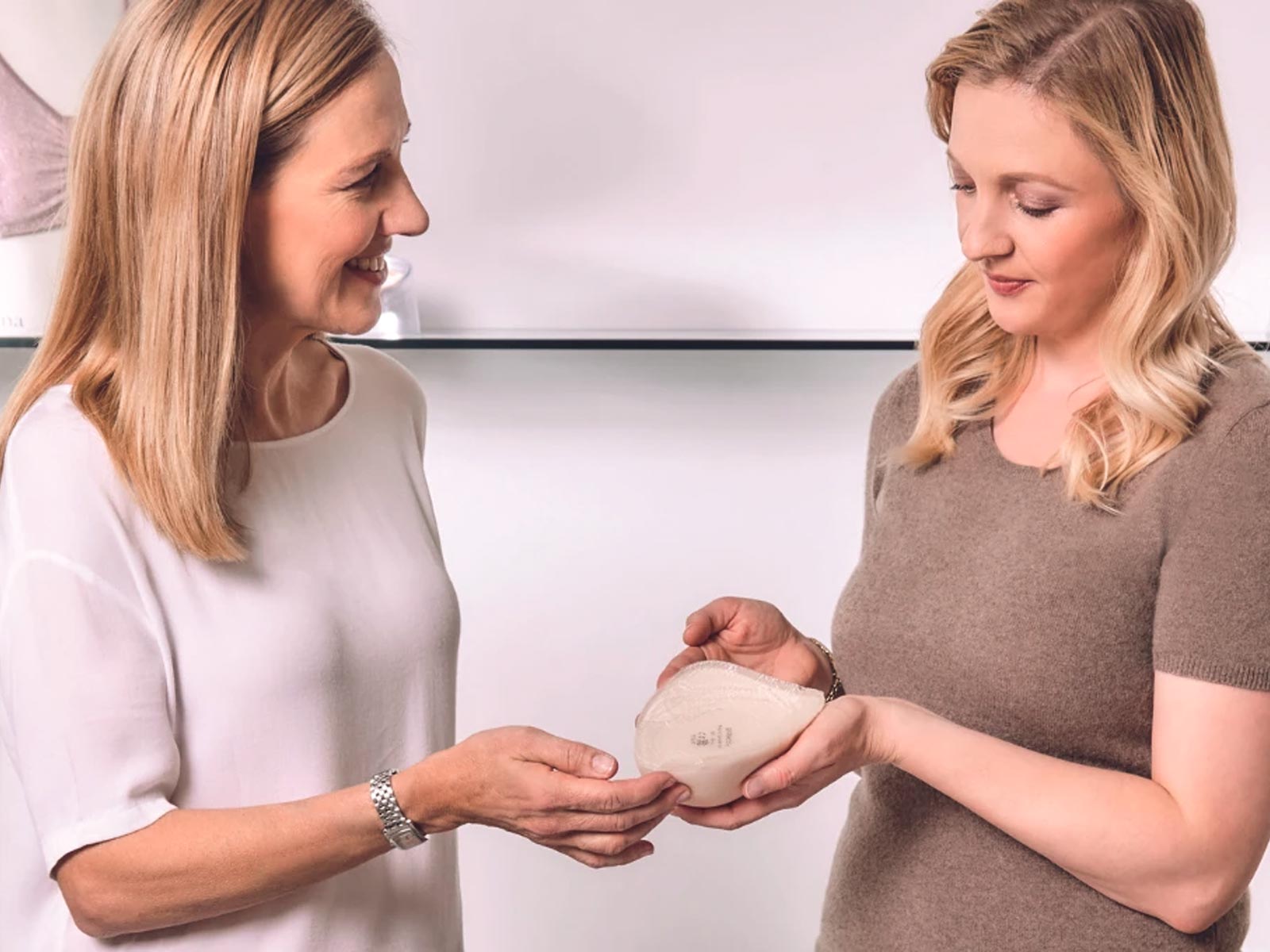 Woman receiving a mastectomy breast prosthesis fitting