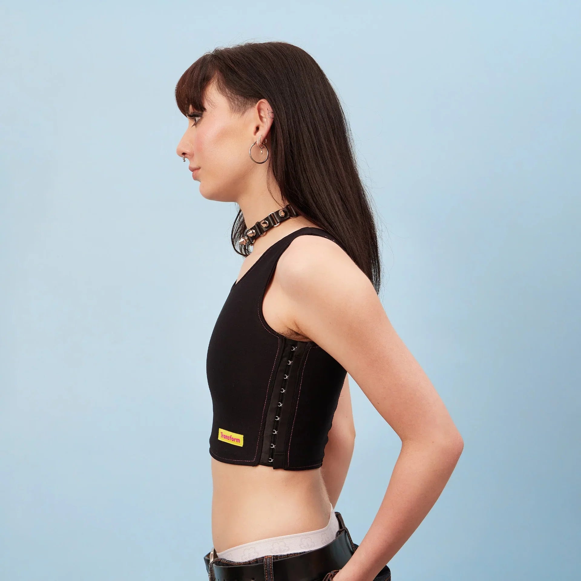 Black lace-up crop top chest binder with yellow puffer label