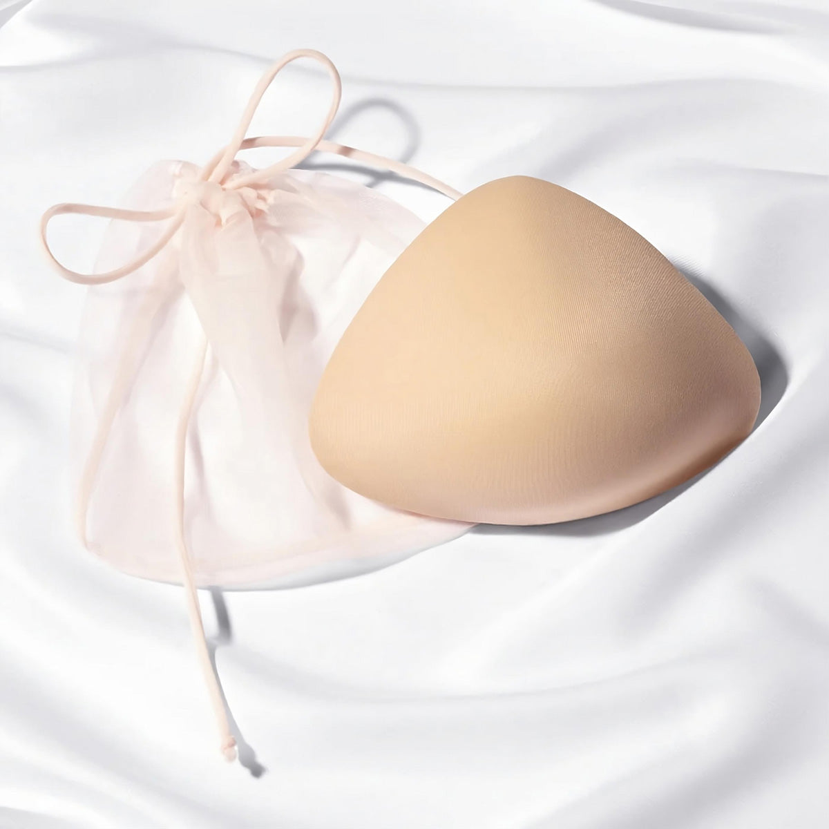 Mastectomy breast form on white silk