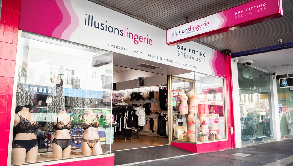 Pink and white storefront of illusions lingerie, an inclusive bra fitting specialists shop.