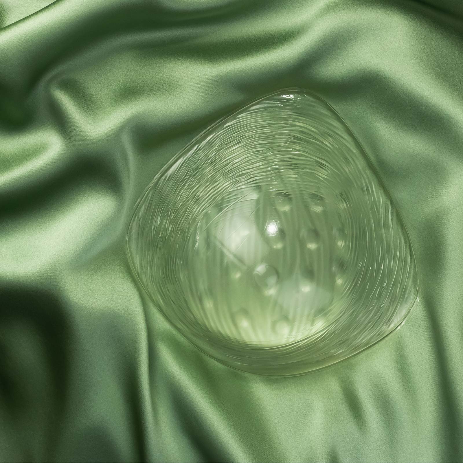 Clear swim form on green silk background