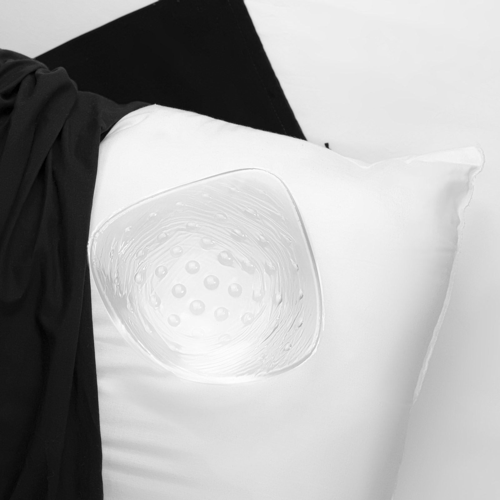 Clear swim form prosthesis on white pillow