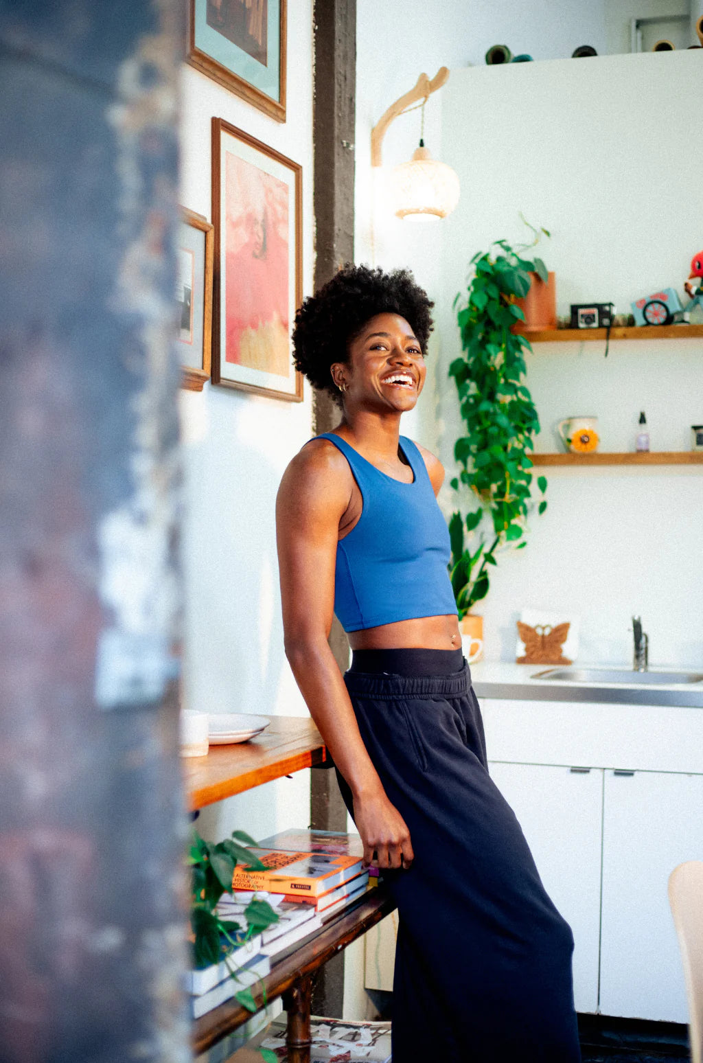 Person leaning against a shelf in a compression top