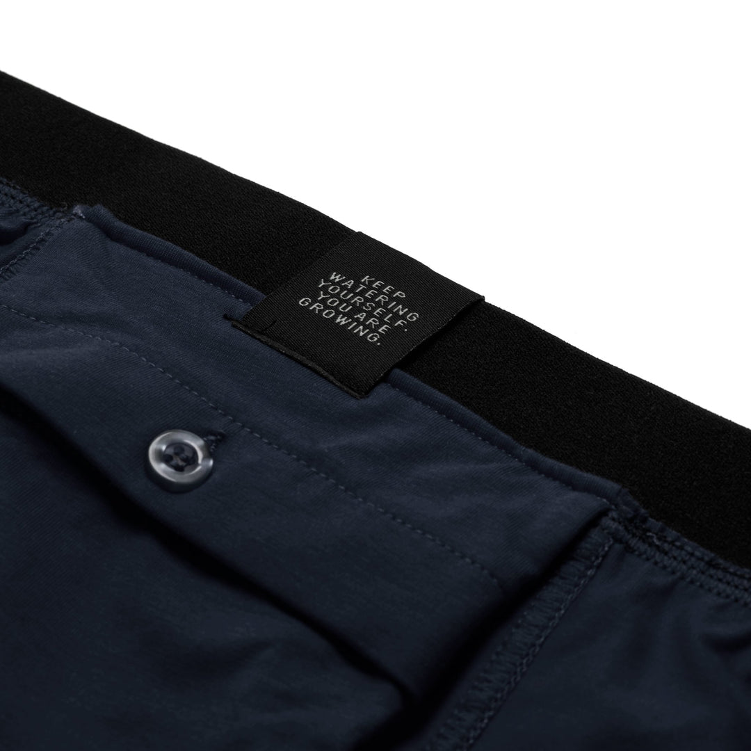 Dark navy blue All-In-One Packing Boxers with black waistband and keep watering yourself label